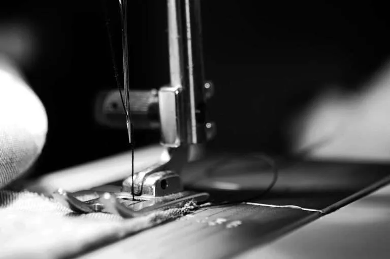 Sewing machine closeup showing needle and bobbin area